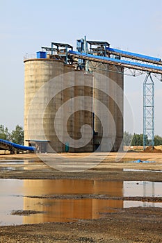 Raw material warehouse and a conveyor belt in a cement factory