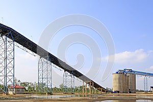 Raw material warehouse and a conveyor belt in a cement factory