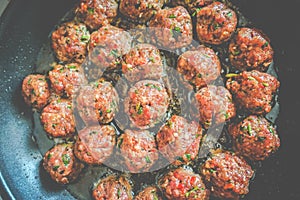 heap of raw meat balls cooking