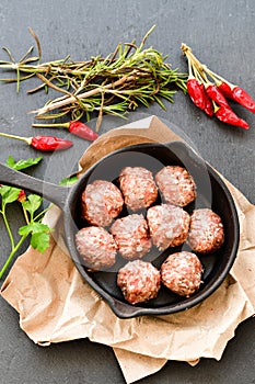 Raw meat balls vintage cast-iron pan