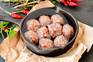 Raw meat balls vintage cast-iron pan