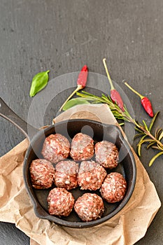 Raw meat balls vintage cast-iron pan