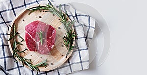 Raw meat, beef steak, on wooden board