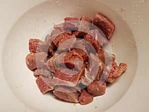 Raw meat beef in white bowl or container