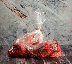 Raw meat and bone packed in plastic bag.Selective focus. Beef bone selection for soup