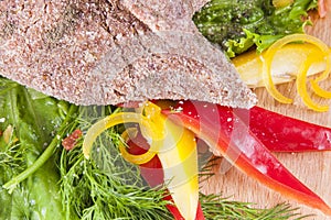 Raw meat cutlet with vegetables
