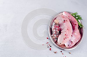 Raw meat for grill, BBQ or cooking with herbs and spices on an iron platter