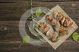 Raw meat kebab on a wooden background