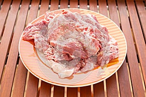 raw meat with marinate and herbs on dish