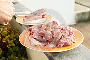 raw meat with marinate and herbs on dish