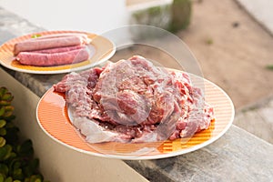 raw meat with marinate and herbs on dish