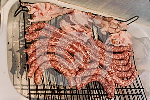 Raw meat put on grills to cook on the coals