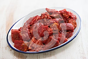 Raw meat with sauce on dish