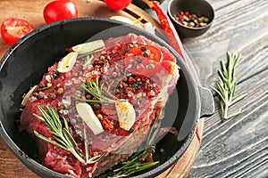 Raw meat with spices on frying pan, closeup