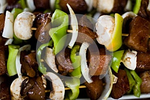 Raw meat spit with onion, pepper and mushrooms