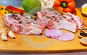 Raw meat steaks with spices cutting board.