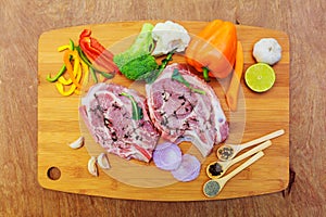 Raw meat steaks with spices cutting board.