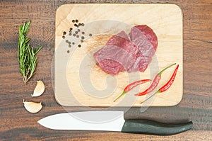 Raw meat, vegetables and chef knife