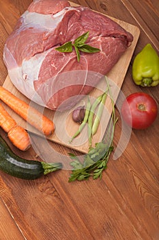 Raw meat and vegetables on a cutting board