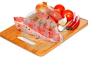 Raw meat and vegetables over the white background
