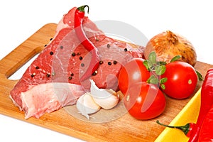 Raw meat and vegetables over the white background