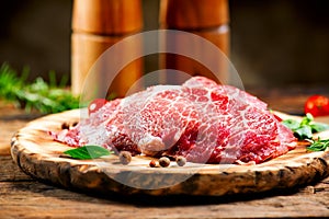 Raw meat on wooden table. Premium juicy Marble beef steak, Black Angus Steak Rib eye. Spices. On wooden plate