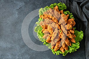 Raw meatballs with lettuce on rustic background