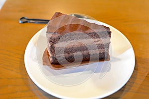 Raw milk chocolate cake and caramel macchiato coffee in the cafe photo