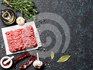 Raw minced beef on light gray cement background