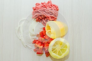 Raw minced meat and fresh vegetables. Ingredients for home cooking