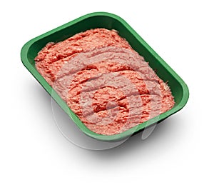 Raw minced meat in a green tray on white background