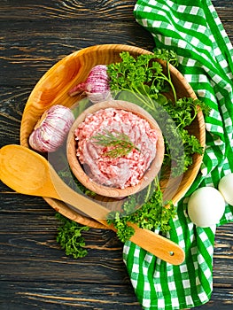 Raw minced meat, parsley kitchen a background uncooked