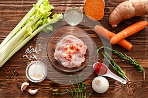 Raw minced meat and raw vegetables in the kitchen