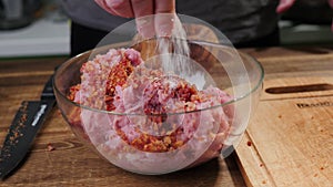 Raw minced pork in a glass bowl.