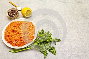 Raw minced red fish stuffing on a stone background. Ingredient for making fish-balls, casseroles, terrine, pate. Spices, salt,