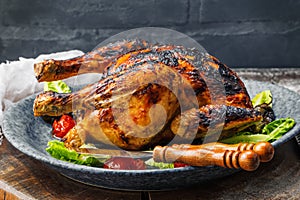 Raw mini Chicken on wooden cutting board with sea salt and different spices over old surface