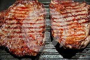 Raw minute steak of marbled beef in a grill pan