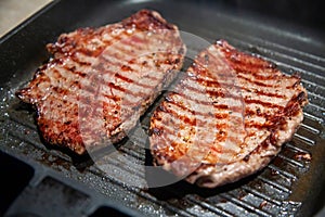 Raw minute steak of marbled beef in a grill pan