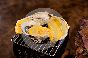 Raw mussel baked with cheese grilled.