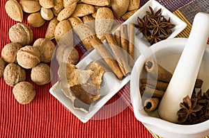 Raw nuts and spices on kitchen table.