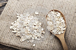 Raw oat flakes in a spoon