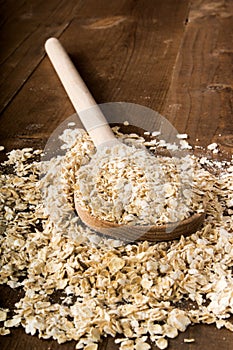 Raw oatmeal and a wooden spoon