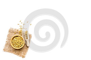 Raw oats in bowl and scoop on white background top view copy space