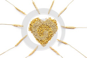 Raw oats in shape of heart on white background top view