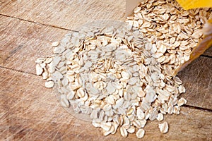 Raw oats wooden cutting board background.