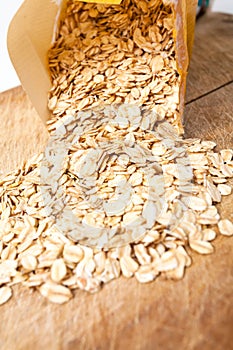 Raw oats wooden cutting board background.