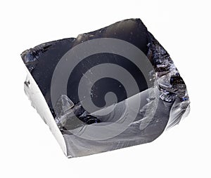 raw obsidian (volcanic glass) stone on white