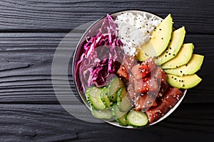 Raw Organic Ahi Tuna Poke Bowl with Rice and Veggies close-up. H photo