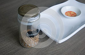 Raw organic Buckwheat in ceramic bowl on white plate