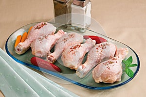Raw organic chicken legs on table